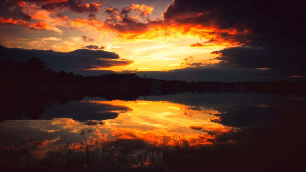 Dark sunset reflection in lake